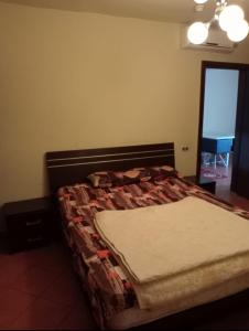 a bedroom with a bed with a quilt on it at اهرامات بورتو السخنة in Ain Sokhna