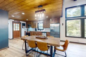 a kitchen with a wooden ceiling and a table and chairs at The Lighthouse in Ellijay