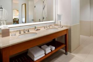 a bathroom with two sinks and a large mirror at The Westin Memphis Beale Street in Memphis