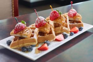 a plate of waffles with berries on a table at The Westin Memphis Beale Street in Memphis
