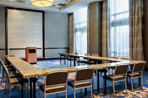 a conference room with tables and chairs and a screen at The Westin Memphis Beale Street in Memphis