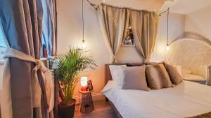 a bedroom with a bed with a canopy at Stunning 2 bedrooms apartment in London