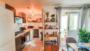 a kitchen with an orange ceiling and wooden floors at Stunning 2 bedrooms apartment in London