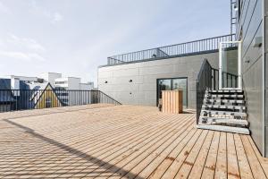 a wooden deck with a staircase on a building at Armas rõduga korter kesklinnas in Tallinn