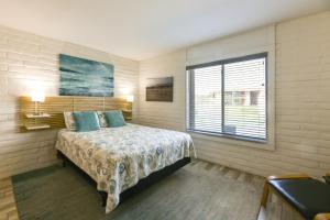 a bedroom with a bed and a window at Direct Beach Access Sunny Port Aransas Condo in Port Aransas +21 photos