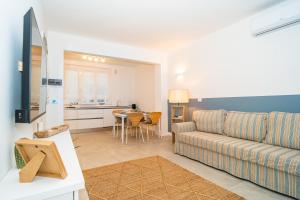 a living room with a couch and a table at H H Moneglia il Vicolo in Moneglia