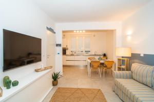 a living room with a couch and a table at H H Moneglia il Vicolo in Moneglia