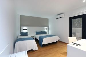 Postel nebo postele na pokoji v ubytování Hotel Alameda