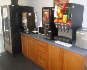 a counter with a drink machine and a refrigerator at Sea Esta Motel II in Long Neck