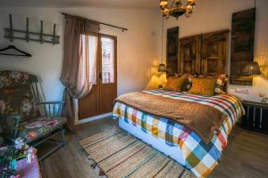 a bedroom with a bed and a chair and a window at Villa de Loarre in Loarre