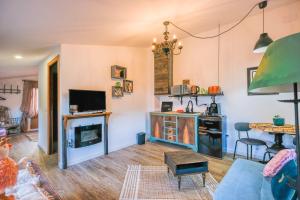 a living room with a kitchen and a living room with a fireplace at Villa de Loarre in Loarre