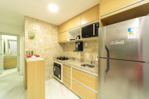 a kitchen with a stainless steel refrigerator at Mirante de porto 108 in Porto De Galinhas