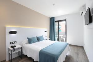 Postel nebo postele na pokoji v ubytování Hotel Alameda