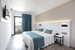 Postel nebo postele na pokoji v ubytování Hotel Alameda