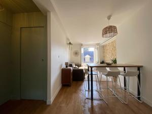 a kitchen and living room with a table and chairs at Duplex cinéma - centre historique Tours in Tours +16 photos