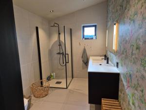 a bathroom with a shower and a sink at New and trendy home with fjord view in Ranheim +16 photos