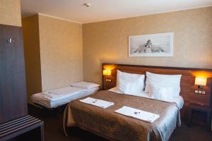 Postel nebo postele na pokoji v ubytování PREMIUM Business Hotel Bratislava
