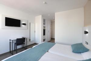 Postel nebo postele na pokoji v ubytování Hotel Alameda