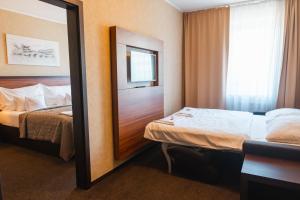 Postel nebo postele na pokoji v ubytování PREMIUM Business Hotel Bratislava