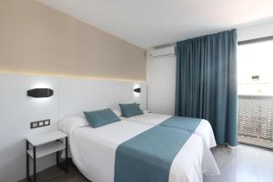 Postel nebo postele na pokoji v ubytování Hotel Alameda