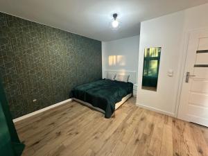 een slaapkamer met een groen bed in een kamer bij Pańska Residence in Gdańsk