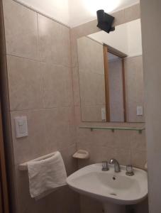 a bathroom with a sink and a mirror at Atenea Departamentos Temporarios in Villa María +15 photos
