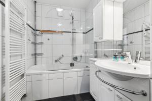 une salle de bain blanche avec lavabo et douche dans l'établissement Stylish Family & Business Apartment in Homburg - nahe Uniklinik - ruhig gelegen - 3 SZ - bis zu 6 Pers - Balkon - Badewanne - WLAN 250 Mb - Parkplätze - Self-Check-in, à Hombourg