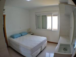 Giường trong phòng chung tại Paraíso de Verão no Condado de Capão