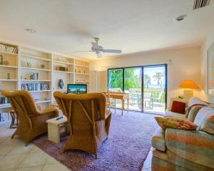 a living room with a couch and chairs and a table at Set Point Home in Ybel