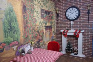 a room with a table and a clock on a wall at Enrico in Dnipro