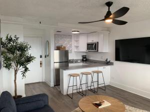 a kitchen with a table and some bar stools at Modern Charm at The George 304 in Klamath Falls