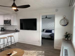 a living room with a kitchen and a bedroom with a bed at Modern Charm at The George 304 in Klamath Falls