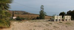 two white chairs sitting on top of a hill at B&B L'EDEN DI CAPO BIANCO in Montallegro