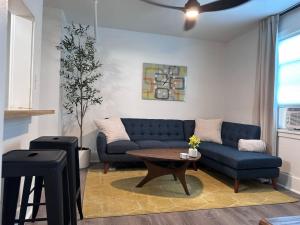a living room with a blue couch and a table at Modern Unit 313 at The George in Klamath Falls