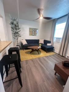 a living room with a couch and a table at Modern Unit 313 at The George in Klamath Falls