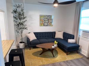 a living room with a blue couch and a table at Modern Unit 313 at The George in Klamath Falls
