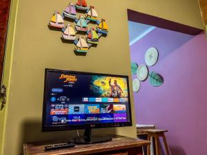 a flat screen tv sitting on top of a table at R6 · Uma obra de arte na sua praia in Guarujá