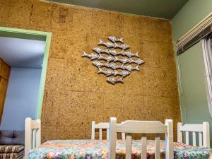 a wall with a bunch of shoes hanging on it at R6 · Uma obra de arte na sua praia in Guarujá