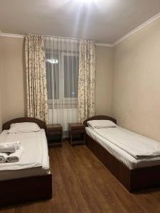 two beds in a small room with a window at Holiday stay Nika in Busk +36 photos