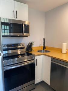 a kitchen with stainless steel appliances and a sink at Rivers Edge Retreat in Clearwater