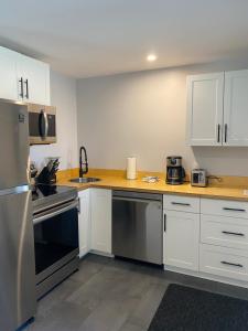 a kitchen with white cabinets and stainless steel appliances at Rivers Edge Retreat in Clearwater +17 photos