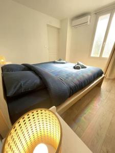 a bedroom with a bed and a chair in it at Le Loft d'Azur - Cozy - Netflix in Fontainebleau +18 photos