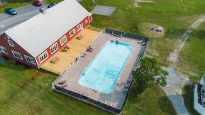 an overhead view of a swimming pool next to a house at Sun Outdoors Association Island in Henderson Harbor