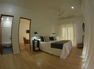 a bedroom with a bed and a table and a mirror at Hotel Milton in La Paz