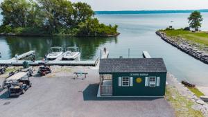 a small boat dock with boats on the water at Sun Outdoors Association Island in Henderson Harbor