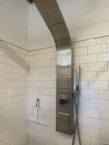 a bathroom with a shower with a phone in it at Tiny Home w Great Bay Views Pets Near Eglin Beach in Freeport +54 photos