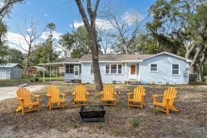 a group of chairs sitting in front of a house at Retro by the Bay Close to Beach Eglin PetFriendly in Freeport