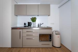 a small kitchen with a sink and a microwave at Altstadtperle in Konstanz