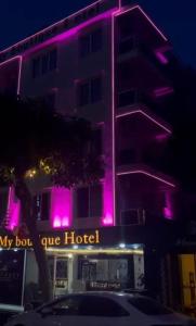 a hotel with pink lights on the side of it at My Boutique Hotel in Alanya