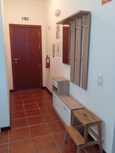 a bathroom with a wooden bench and a mirror at Sunrise Holidays in Porto Santo +10 photos